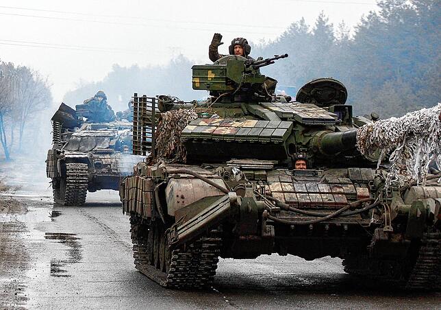 Ukrainische Soldaten fahren am 25. Februr kurz nach Kriegsbeginn auf Panzern an die Front in der Region Lugansk.