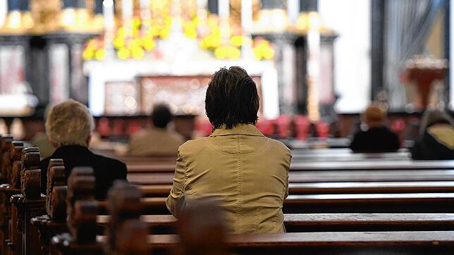 Eine Frau hat sich beim Gottesdienst Dom von Fulda hingesetzt. Der Gottesdienst an Weihnachten ist nicht irgendeine Hauptversammlung, er ...
