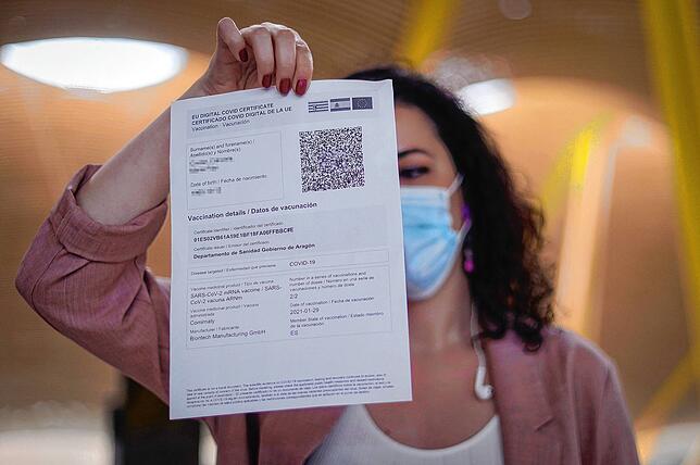 Eine Frau zeigt ihr digitales Corona-Impfzertifikat der EU an einem Flughafen. Doch Vorsicht: Es gilt eine Übergangsfrist bis Mitte ...