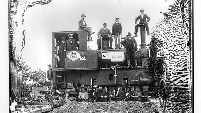 Mitarbeiter der Firma Möbus aus Berlin Charlottenburg sitzen auf der Lokomotive. Bis Oktober 1901 bauten sie die Eisenbahn von ...