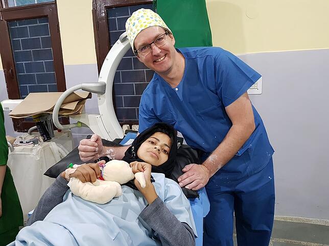 Dirk Thümmler mit einer jungen Patientin in Indien: Das Mädchen hatte eine schwere Verbrennung am Fuß erlitten, die Narbenstränge haben ...