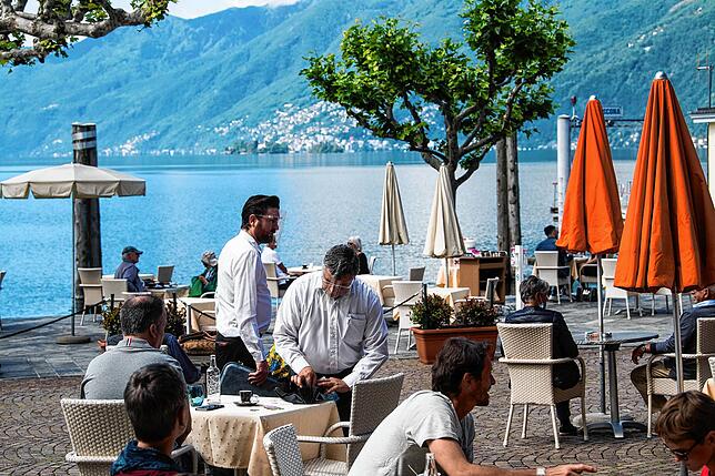 Ein Restaurant an der Uferpromenade des Städtchens Ascona im Kanton Tessin: Im Hintergrund ist der Lago Maggiore zu sehen.