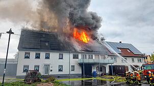 Die Flammen schlagen aus dem Dach des Wohngebäudes.