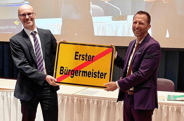 Jetzt hat er‘s schriftlich: Frank Kahle, Leiter des Baubetriebsamts (links), übergibt ein Straßenschild als Symbol für den Weg, ...