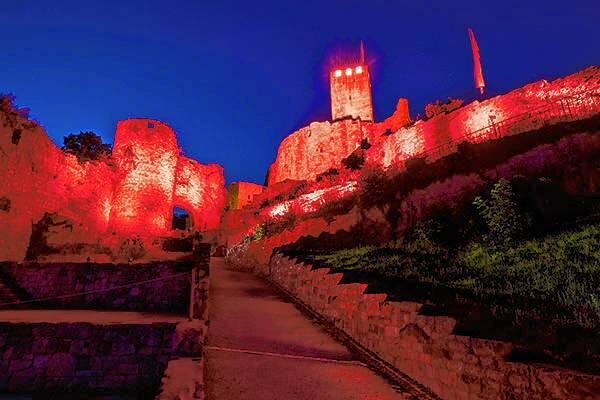 Night of Light: Die Burgruine Rötteln in Lörrach ist rot beleuchtet.
