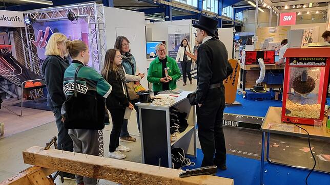 Jugendliche im Gespräch mit einem Schornsteinfeger und Alexandra Hagen-Ettl (Handwerkskammer Konstanz) am Stand der HWK auf der Jobs for ...