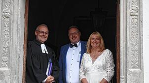 Sie haben 2024 einfach und spontan geheiratet: Andrea und Volker Rothenburg mit Pfarrer Kai Tilgner an der Kapelle von Schloss Langenstein.