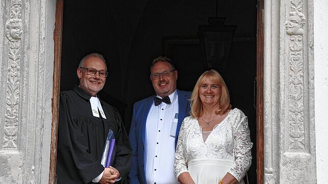 Sie haben 2024 einfach und spontan geheiratet: Andrea und Volker Rothenburg mit Pfarrer Kai Tilgner an der Kapelle von Schloss Langenstein.