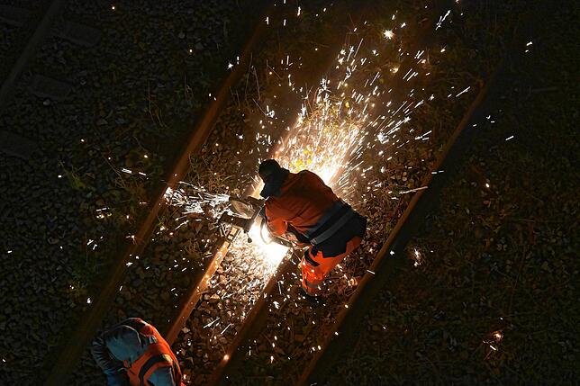 Mit einem Metallfräser werden die Gleise getrennt, um sie für den Transport umzulegen.