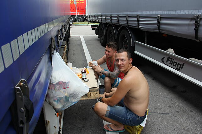 Ihre Heimat liegt weit entfernt: Vitalii (vorne) ist der Fahrer. Aus einer Palette bastelte der Ukrainer einen provisorischen Tisch. ...