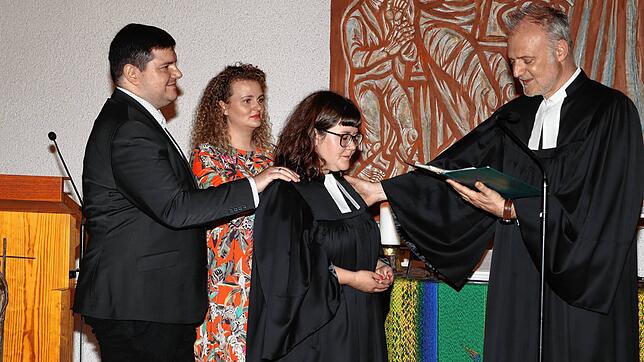 Ein ganz feierlicher Moment: Sofie Fiebiger wird von Dekan Markus Weimer (rechts) offiziell als Pfarrerin der ...