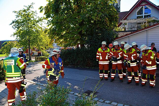 Einsatzleiter Philipp Elmer (links) informiert die Gruppenführer über die Lage vor Ort. Die Gruppenführer weisen danach die Wehrleute ...