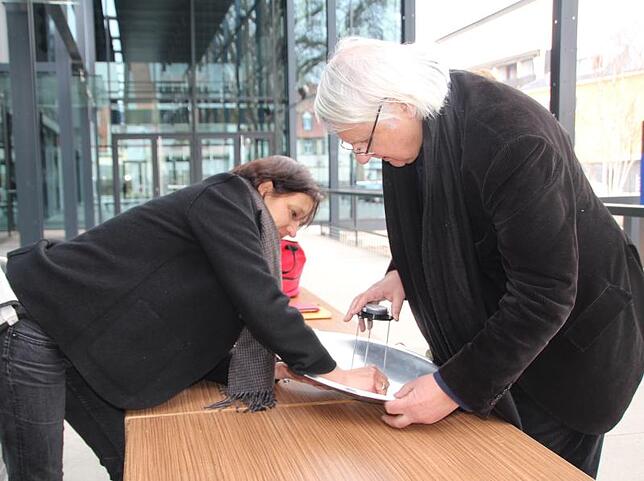 Kulturamtsleiterin Lina Mell und Künstler Bernhard Leitner bereiten den Parabolspiegel vor.