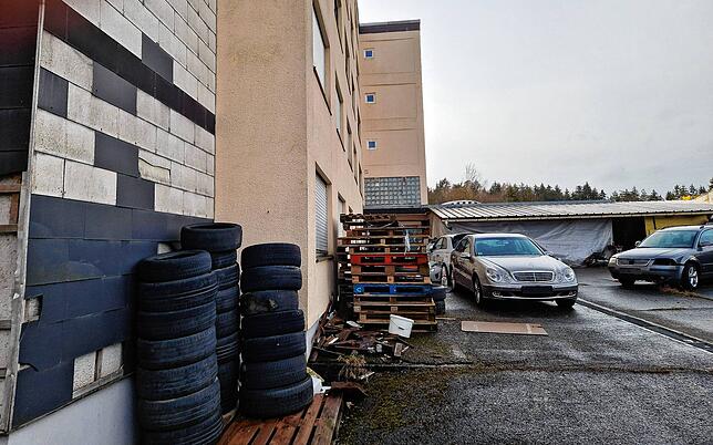 Alte Reifen, Paletten, zwei Autos: So sieht es im Hinterhof des Hauses aus.