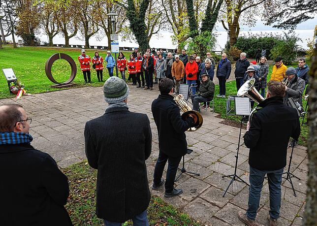 Bei der Einweihung der Gedenkstätte haben sich einige Menschen im Mettnaupark versammelt.