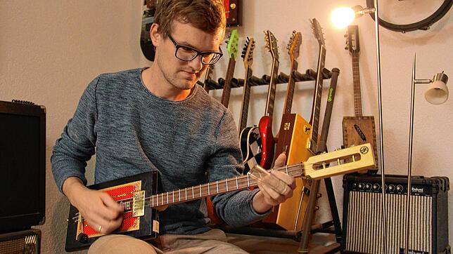 Jan Klingenberg mit seinen selbst gebauten Gitarren &ndash; aus Altmaterial wie weggeworfenem Spielzeug.