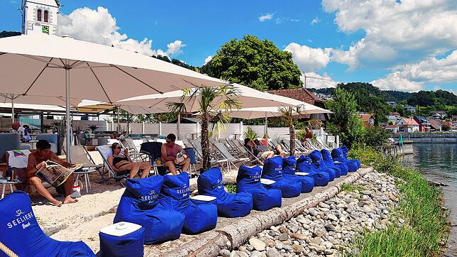 Urlaubsgefühle im Seeliebe Beach Club in Sipplingen: Gäste können ihre Getränke mit Blick auf den Bodensee und Sand zwischen den Füßen ...