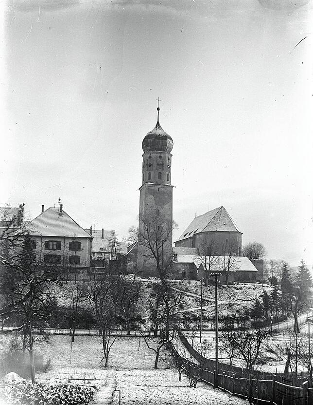 Die Kirche von 1932. Das Gebäude war kleiner und anders. Auf der historischen Aufnahme sind Klammern am Kirchturm zu sehen, die nach dem ...
