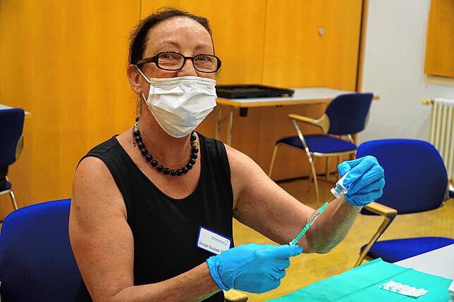 Sonja Gutzeit zieht hier als freiwillige Helferin die Spritzen auf bei der Sonderaktion in der Neuen Tonhalle auf.
