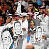 Zuschauer halten im Al-Bait Stadion in Katar Bilder von Deutschlands ehemaligem Nationalspieler Mesut Özil in die Höhe und halten sich ...