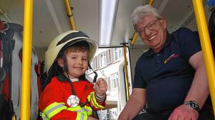 Das ist der kleine „Feuerwehr-Chef“ Friedrich. Er sitzt neben einem großen Kollegen in einem richtigen Feuerwehrfahrzeug auf dem ...