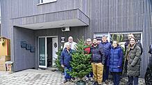 Gruppenbild mit Weihnachtsbaum. Die stolzen Bauherren mit den ersten Gästen: Von links Giovanni Carvelli, Bürgermeister Michael Rieger, ...