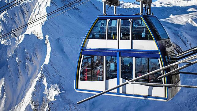 Die Doppelstockbahn im Skigebiet Silvretta Arena bringt Skifahrer zur Bergstation. Das Skigebiet befindet sich in Österreich und der ...
