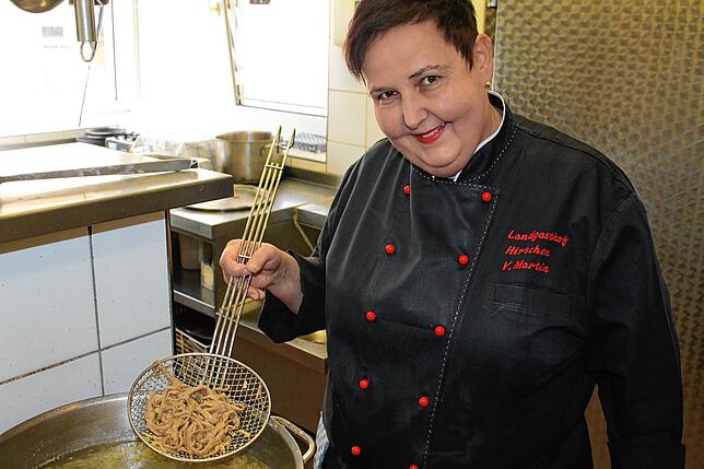 Verena Martin schöpft die frisch geschabten Spätzle aus dem heißen Wasser, um den Garprozess zu stoppen, damit sie nicht matschig werden.