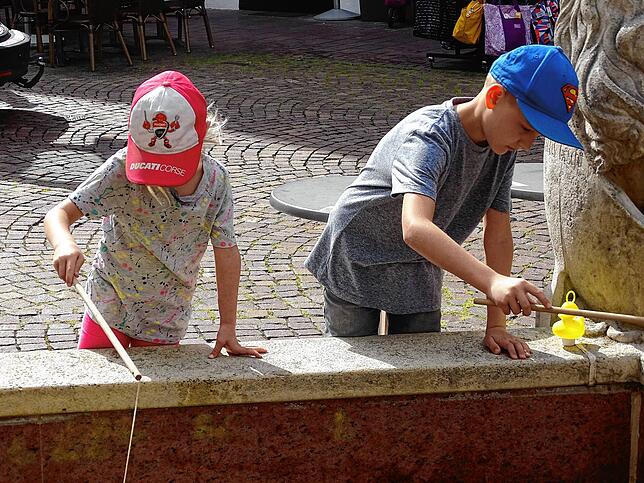 Lea und Joel versuchen ihr Glück beim Entenangeln am Brunnen vor dem Unteren Tor.